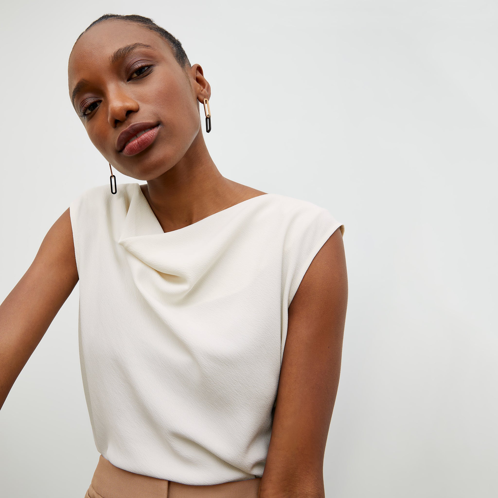 Front image of a woman wearing the Nora Top in Alabaster