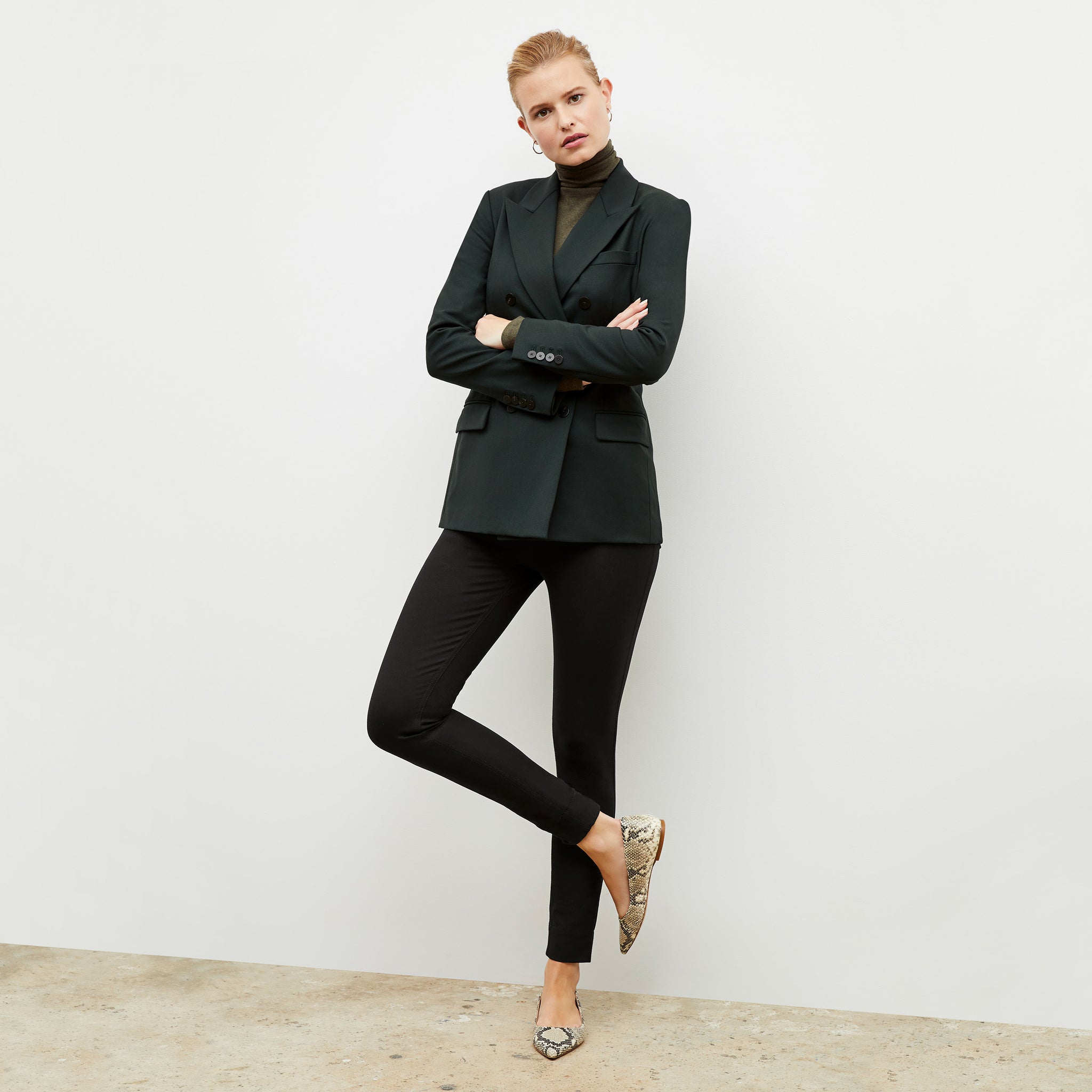 Front image of a woman wearing the kati jacket in forest