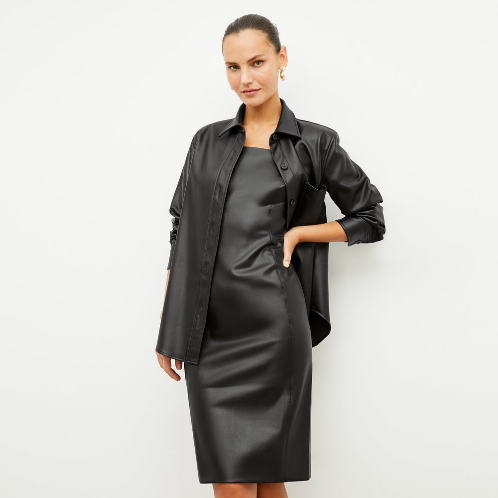 Front image of a woman wearing the noa dress in black