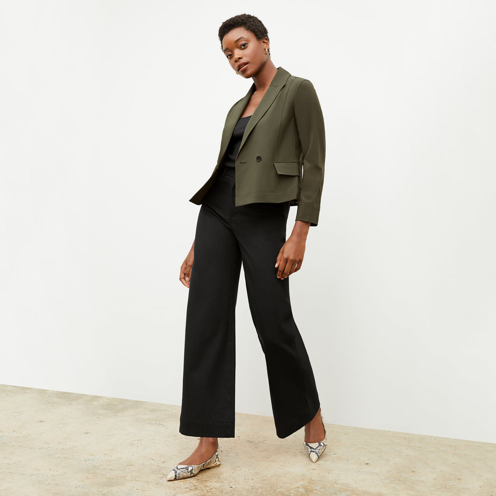 Front image of a woman wearing the nia jacket in olive