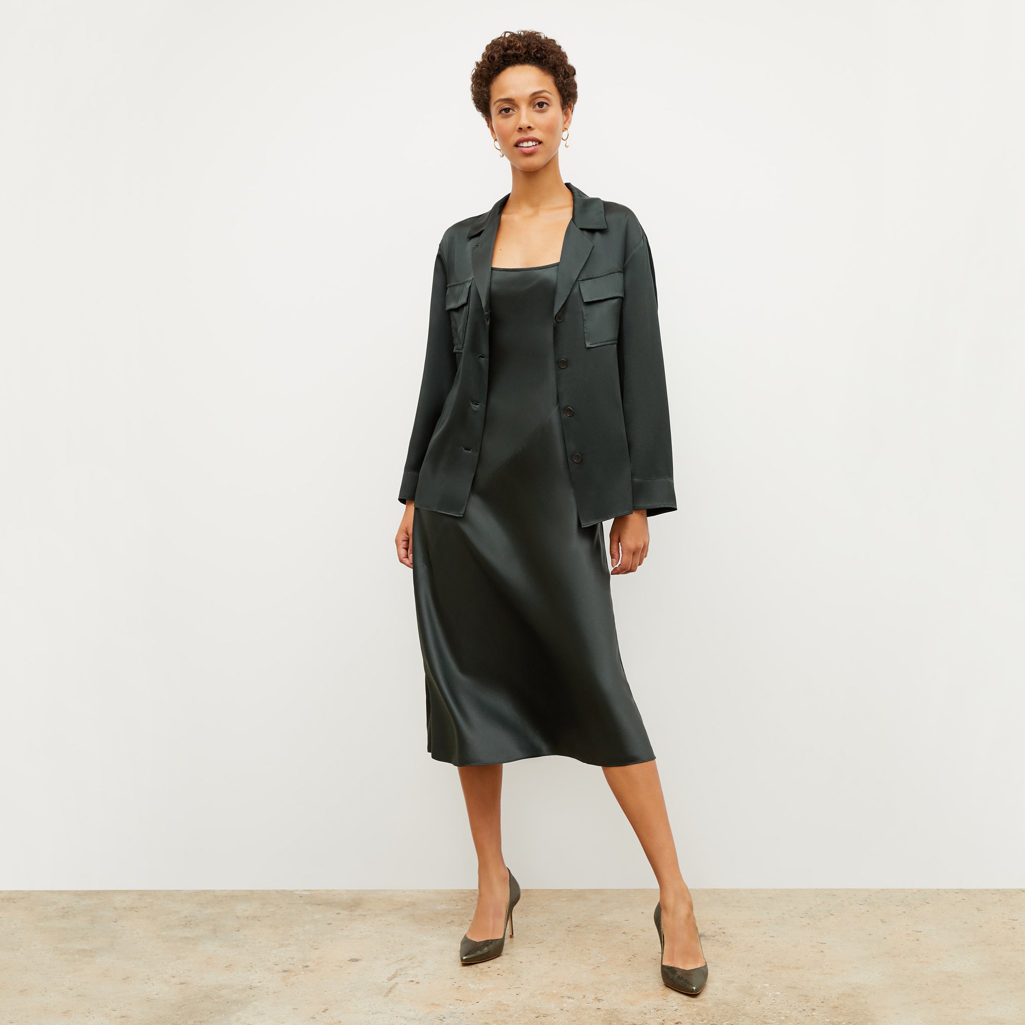 Front image of a woman standing wearing the nene dress in hunter