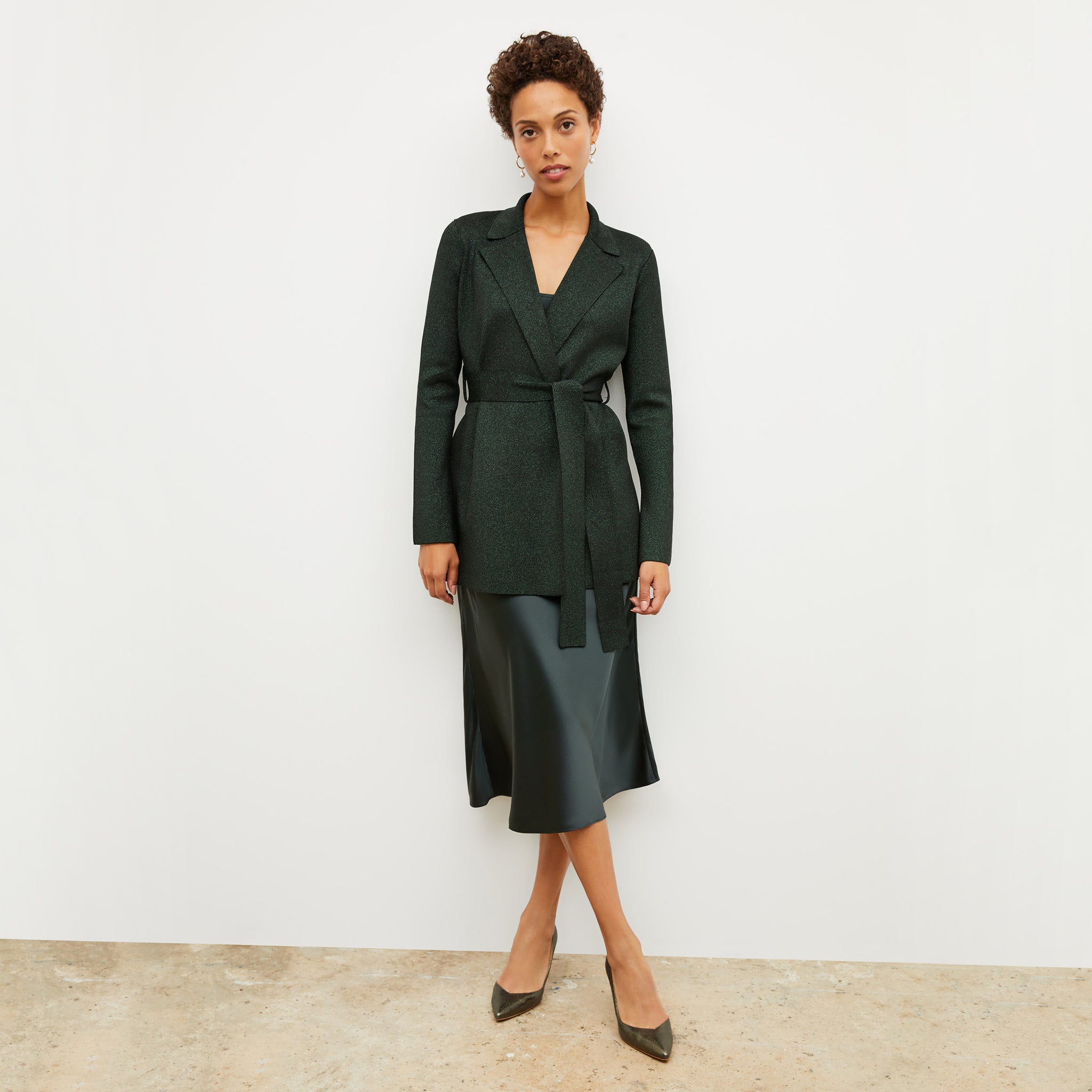 Front image of a woman standing wearing the nene dress in hunter