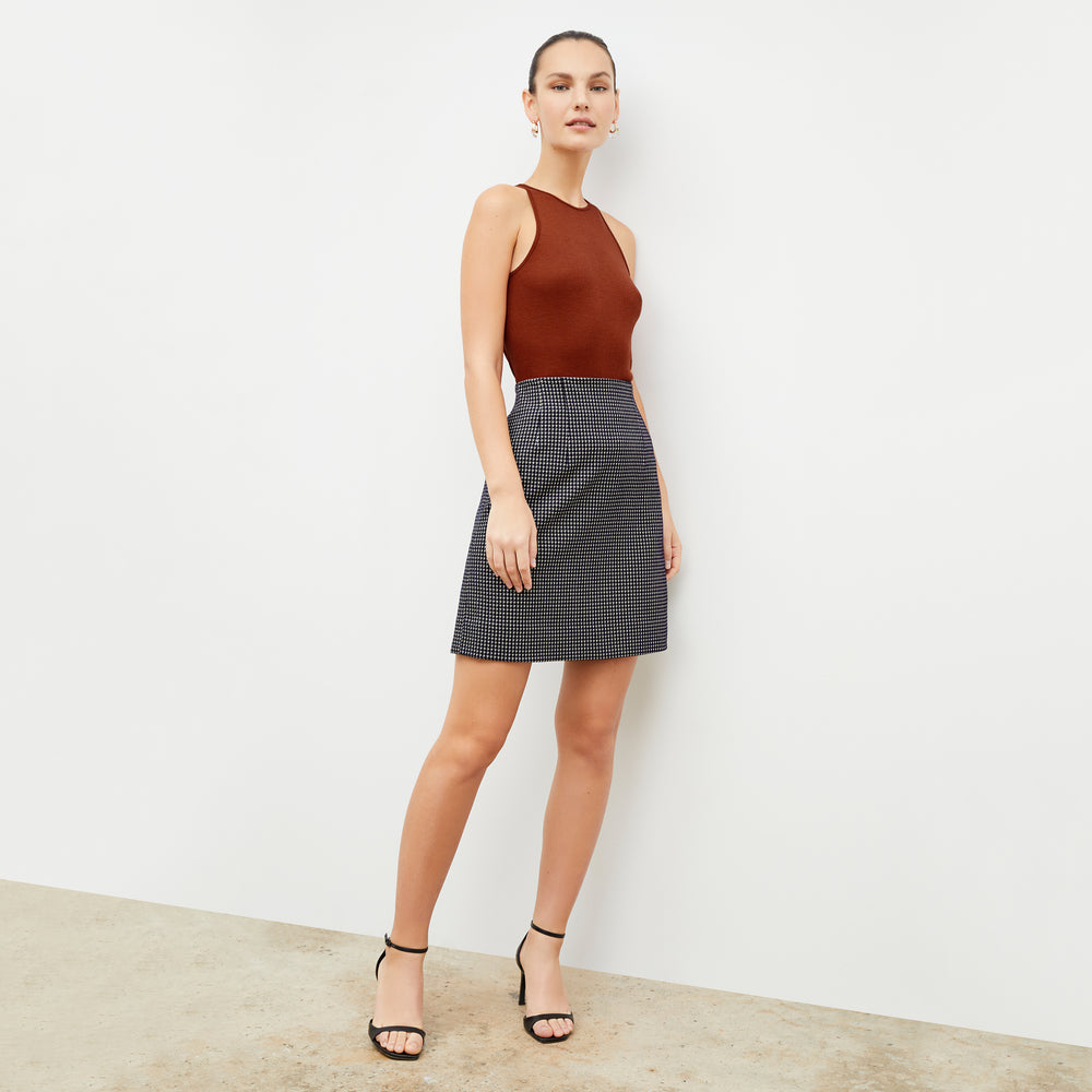 Front image of a woman wearing the whitney skirt in black and white