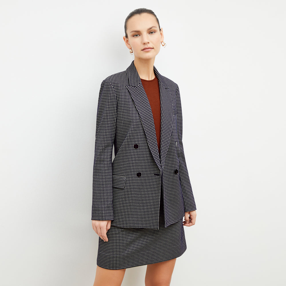 Front image of a woman wearing the ohara blazer in black and white