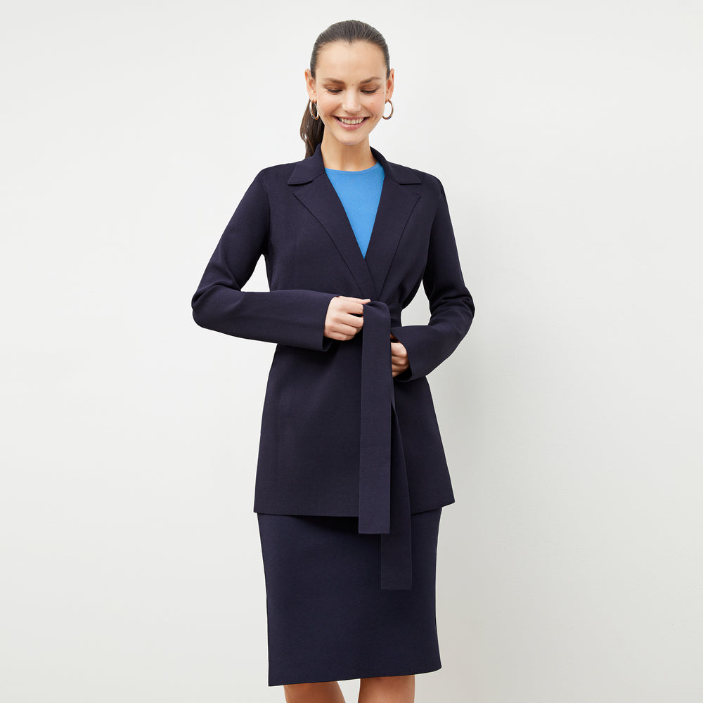 Front image of a woman wearing the harlem skirt in navy