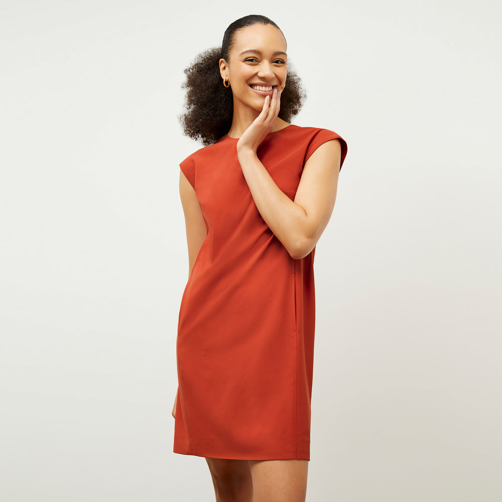 Front image of a woman wearing the Maaza Dress in Blood Orange