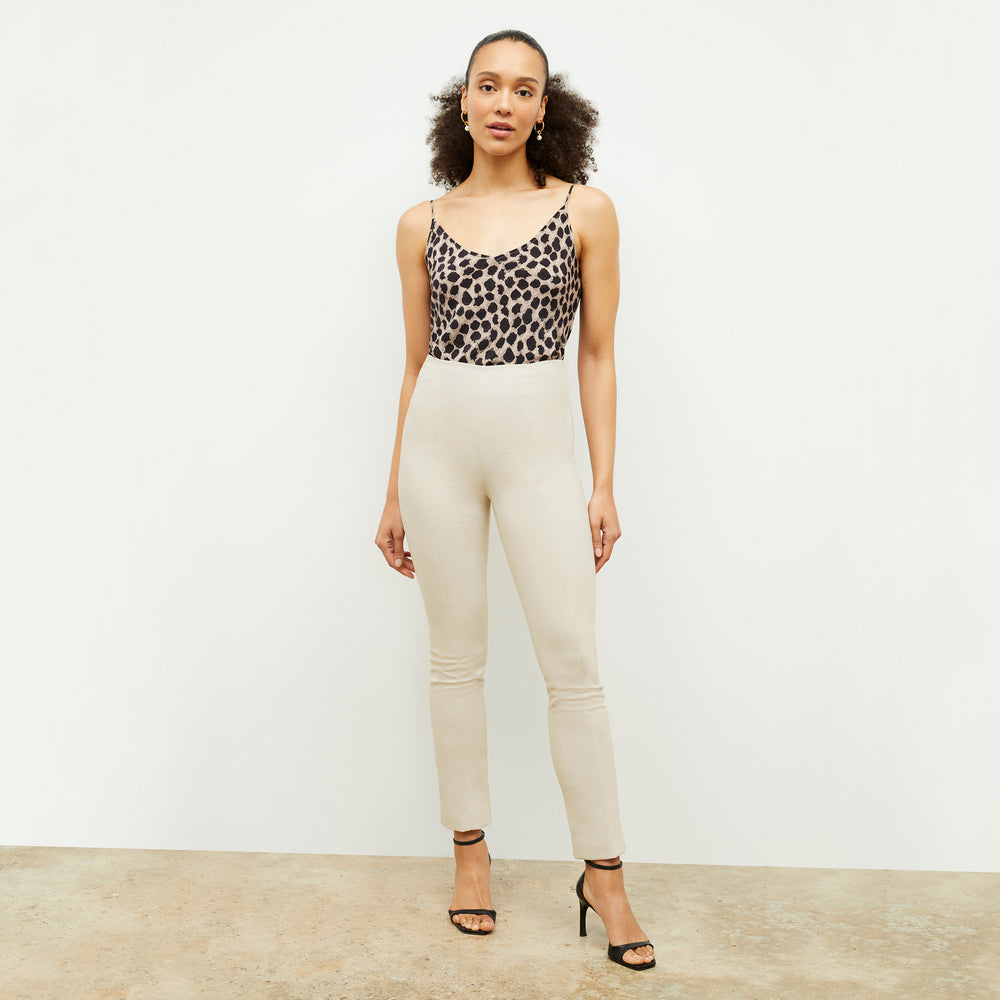 Front image of a woman standing wearing the foster pant in bone