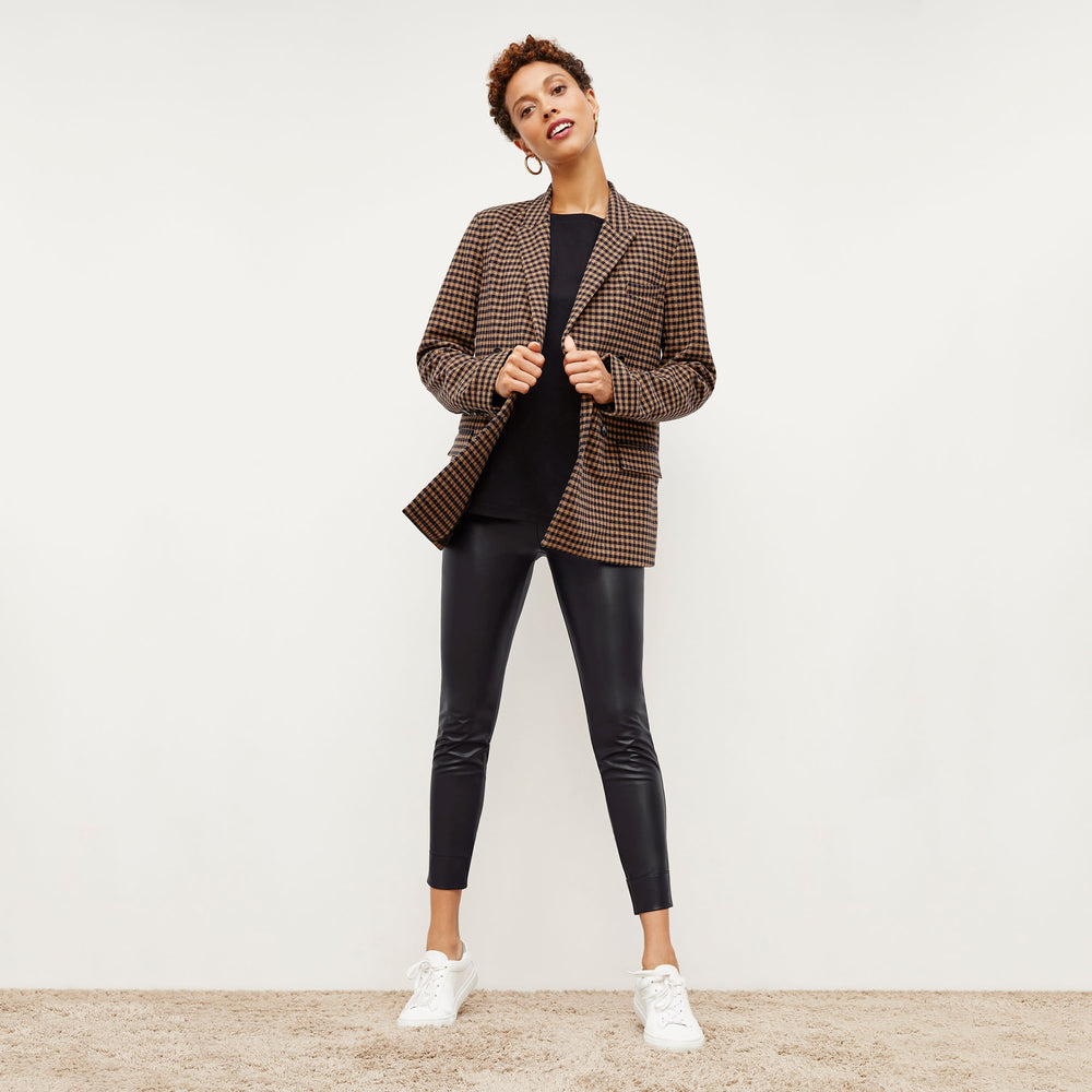 Front image of a woman standing wearing the Harrington Leather—Vegan Leather in Black