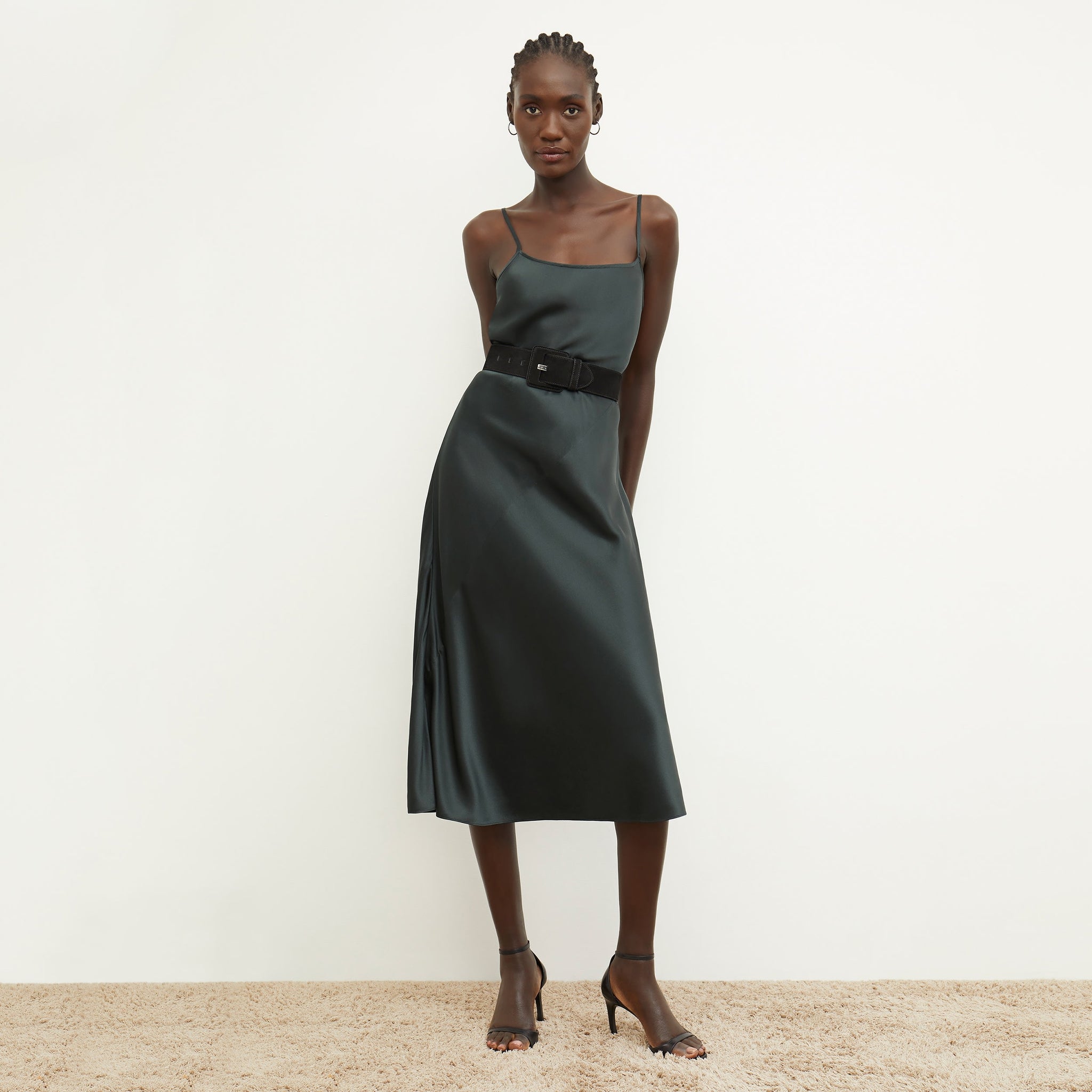 Front image of a woman standing wearing the nene dress in hunter