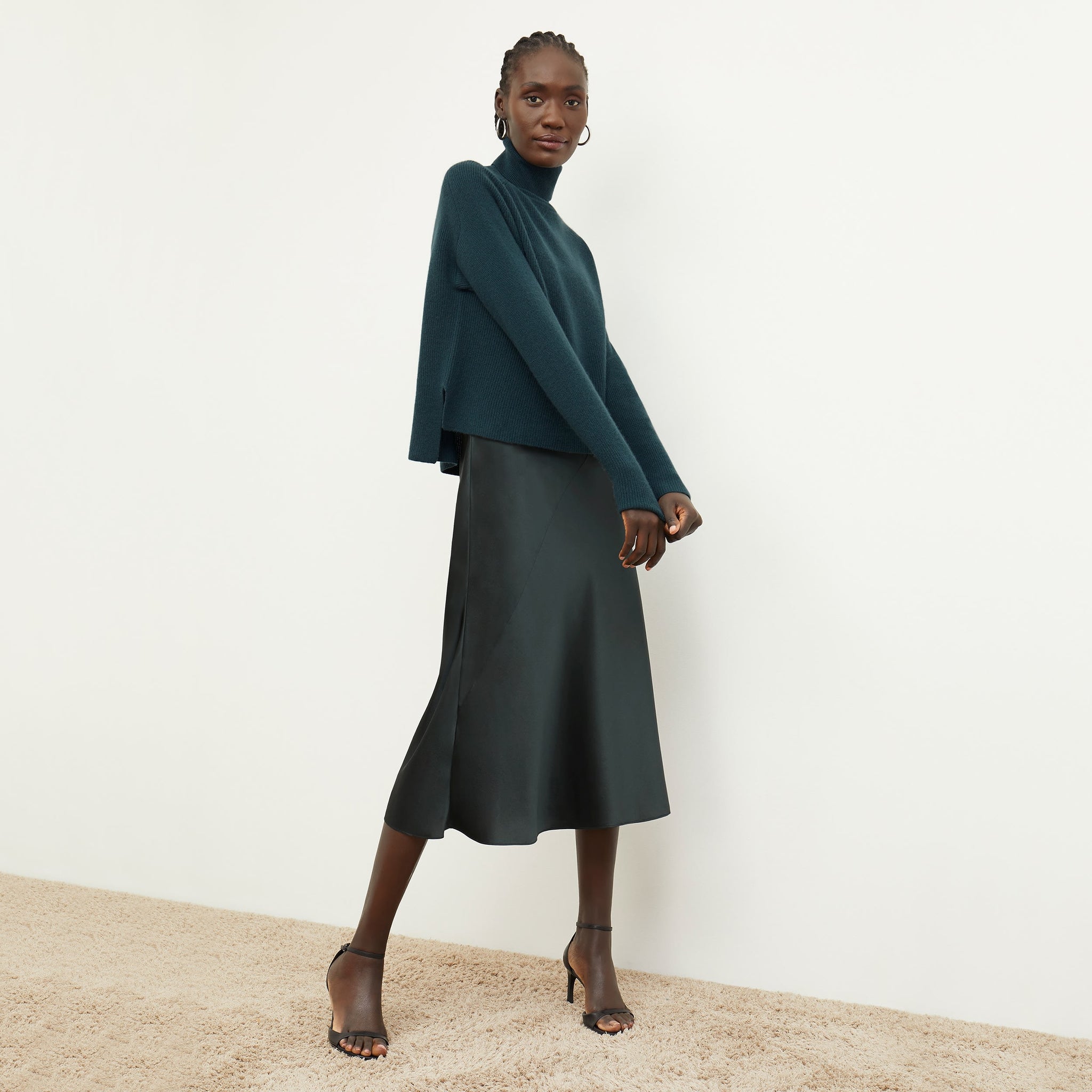 Front image of a woman standing wearing the nene dress in hunter