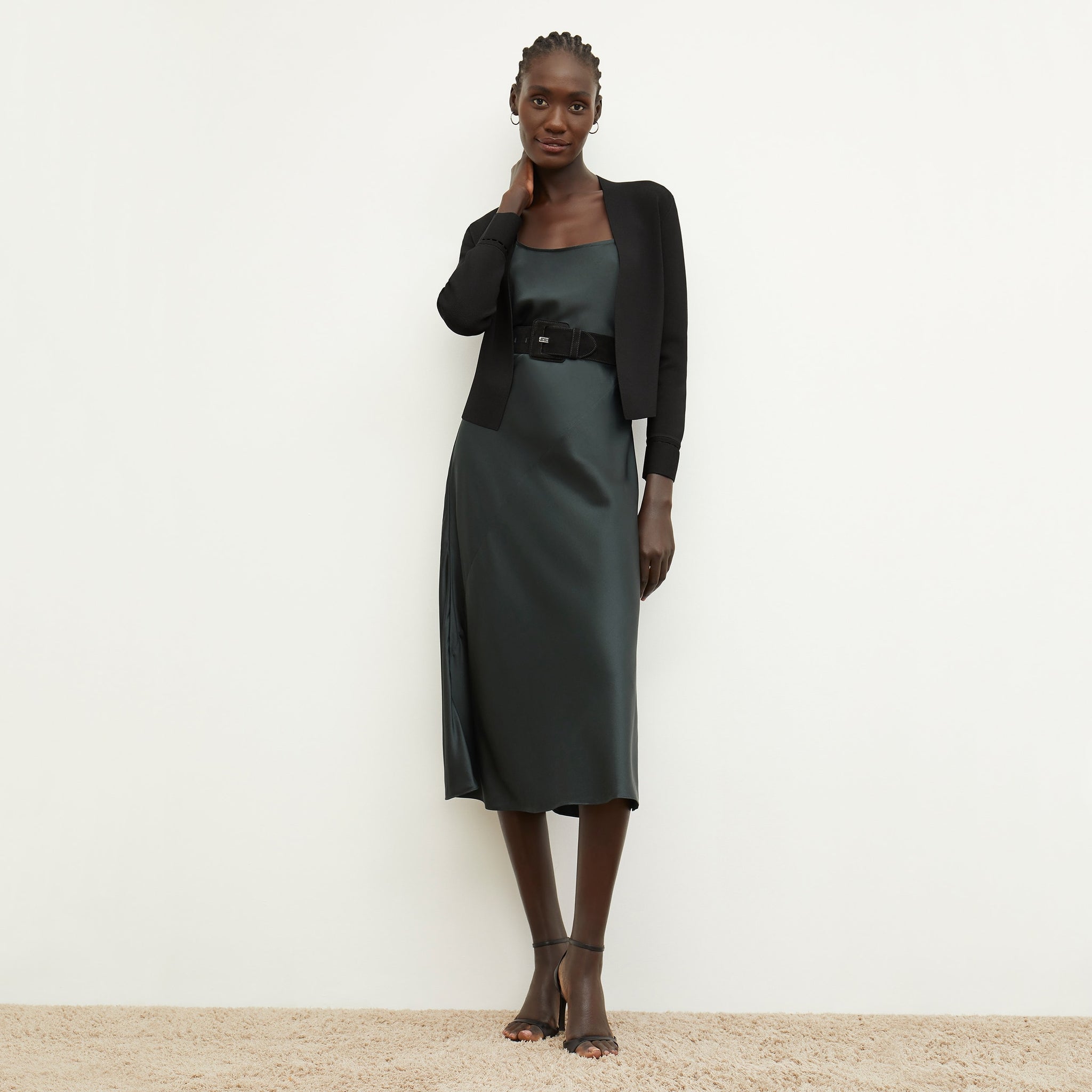 Front image of a woman standing wearing the nene dress in hunter