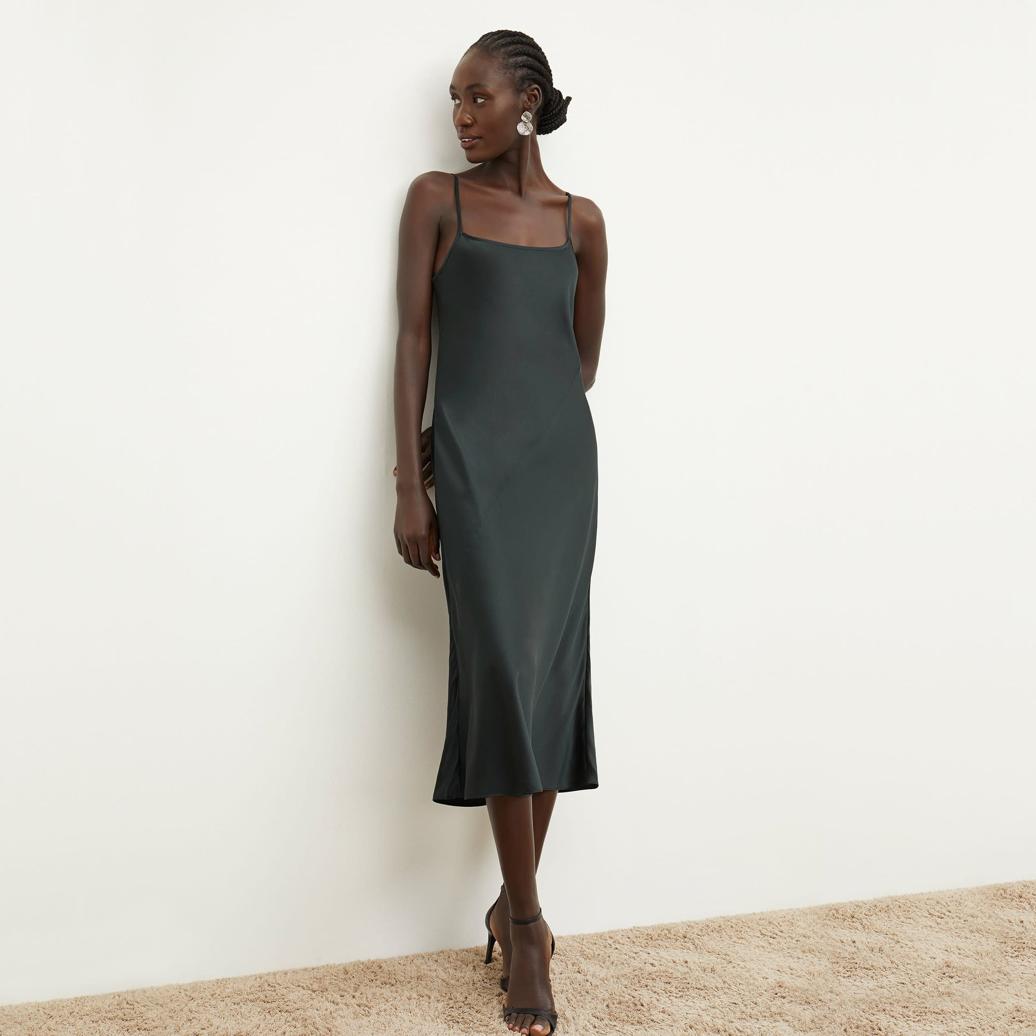 Front image of a woman standing wearing the nene dress in hunter 