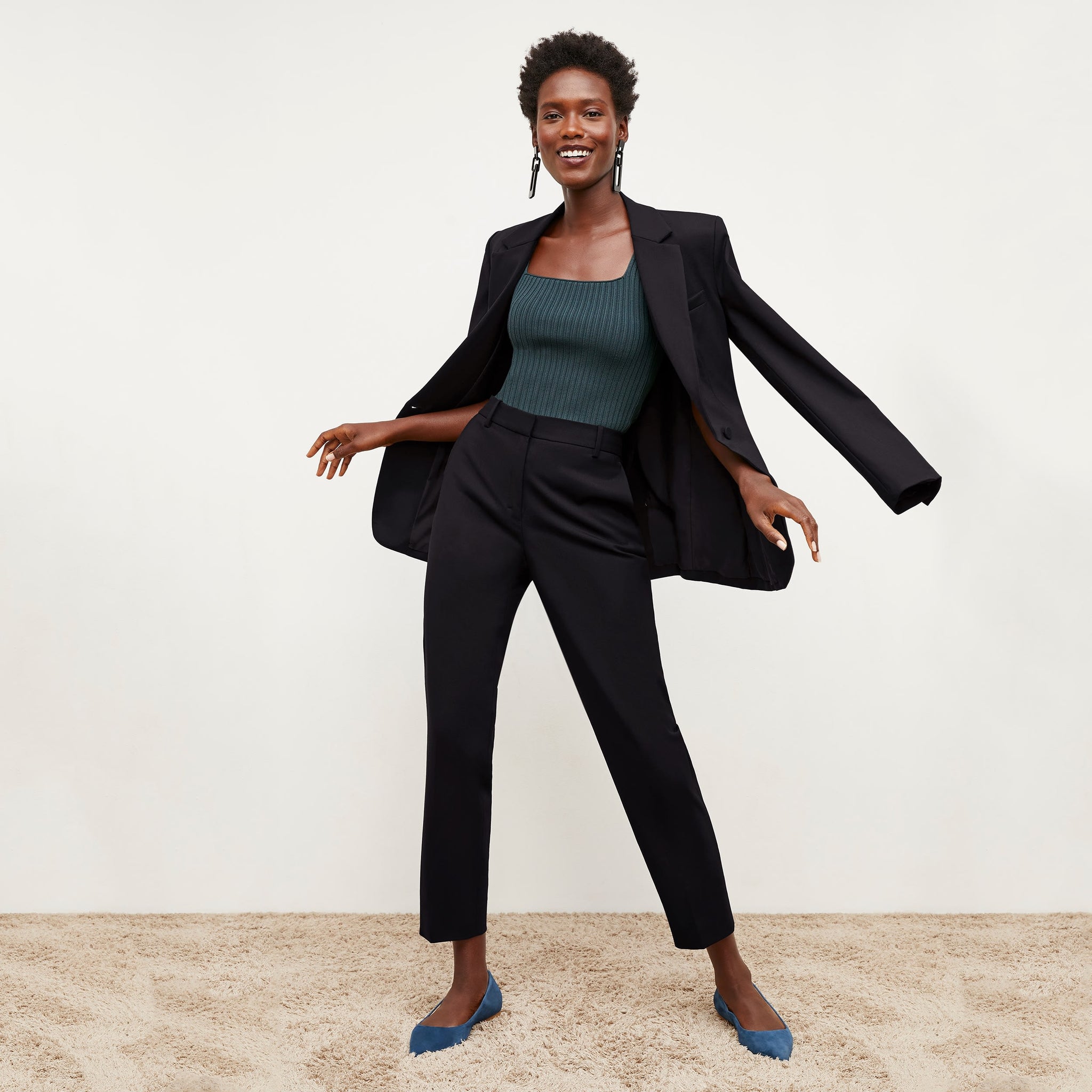 Front image of a woman standing wearing the Yiyan Blazer in Black